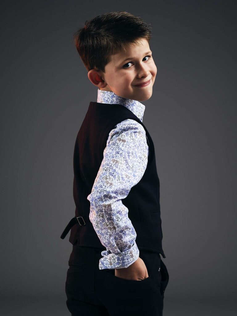 Boy posing looking over his shoulder.