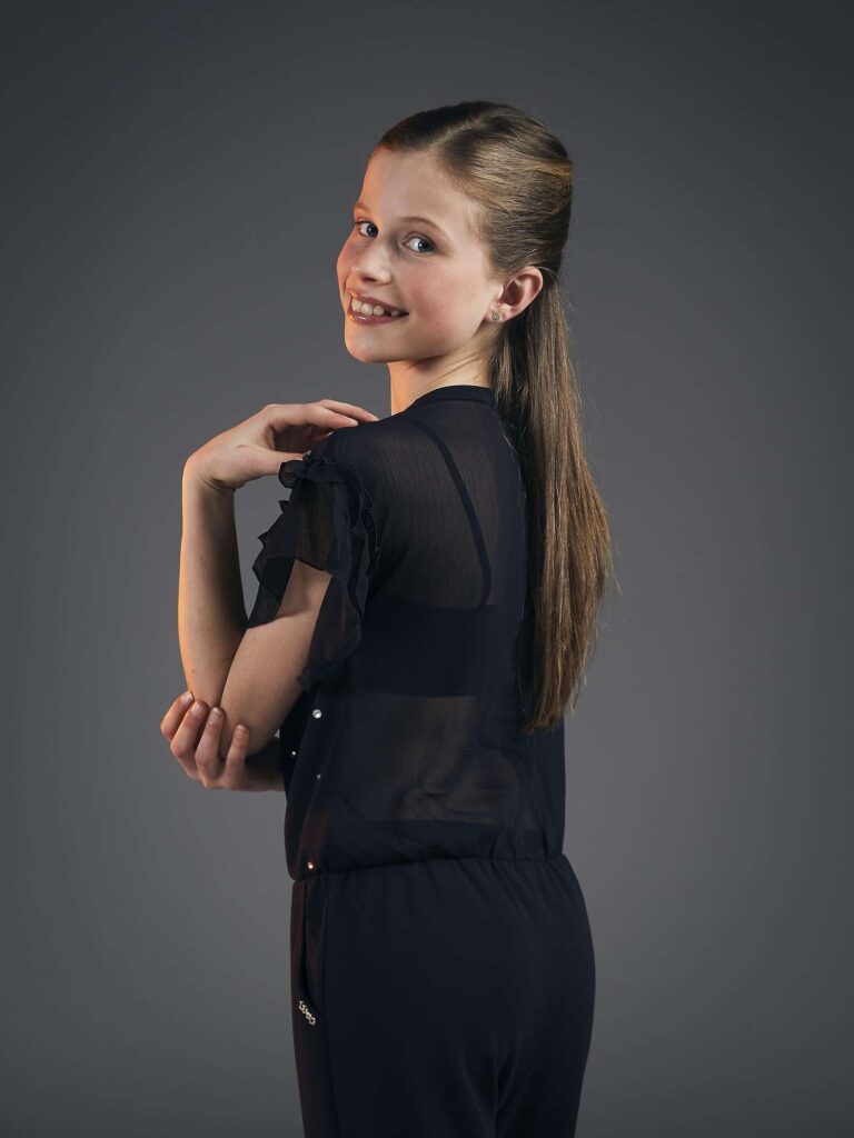 Girl posing looking over her shoulder.