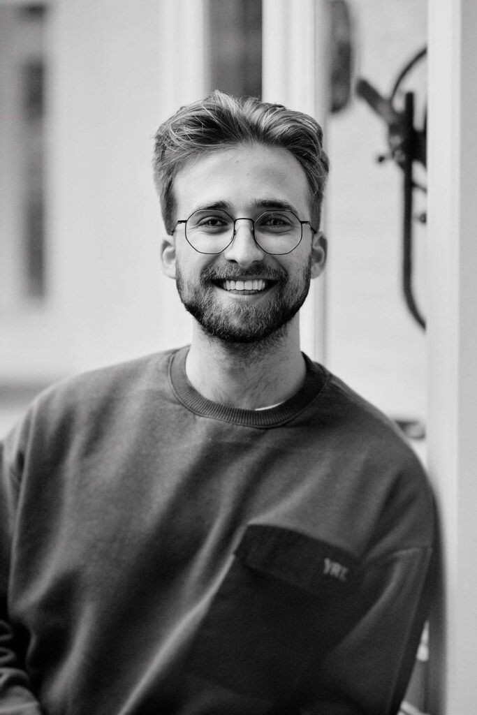 Portrait of a smiling man with glasses on.