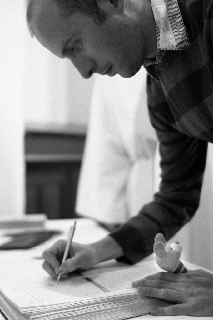Man writing in a register.