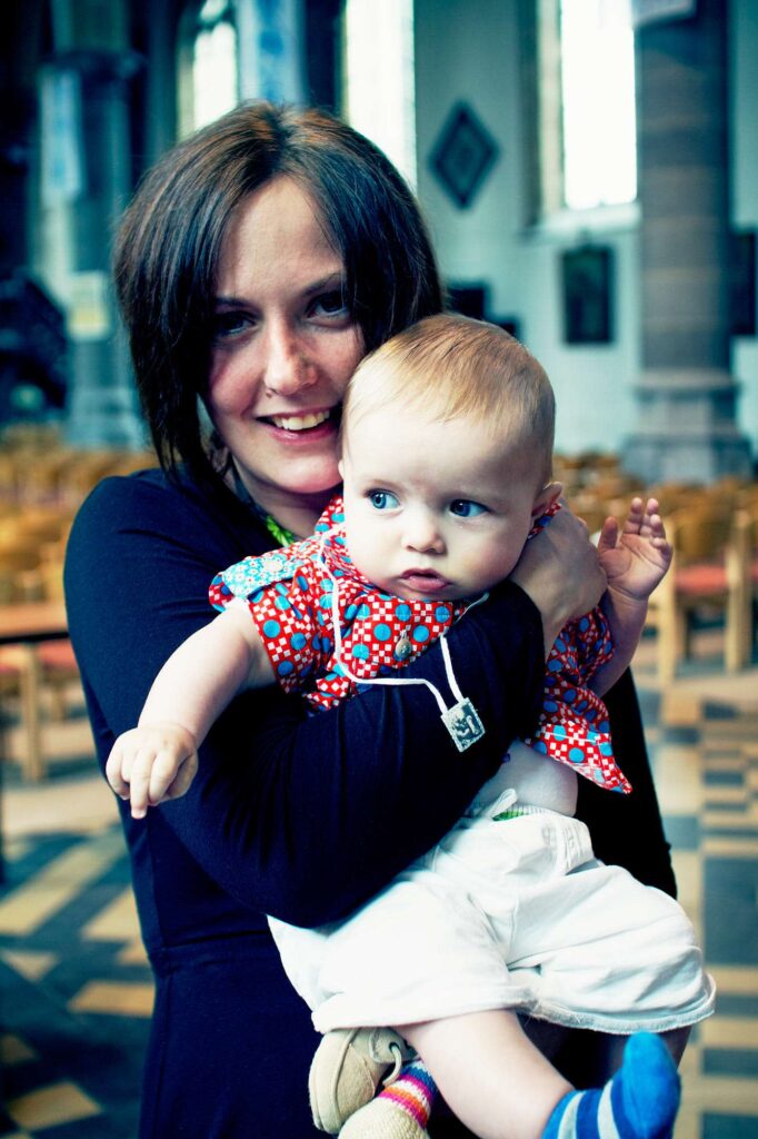 Lady holding her son.