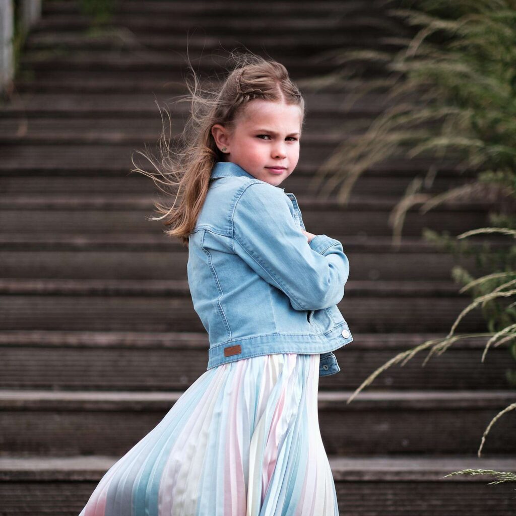 Portrait of a girl posing in front of steps.