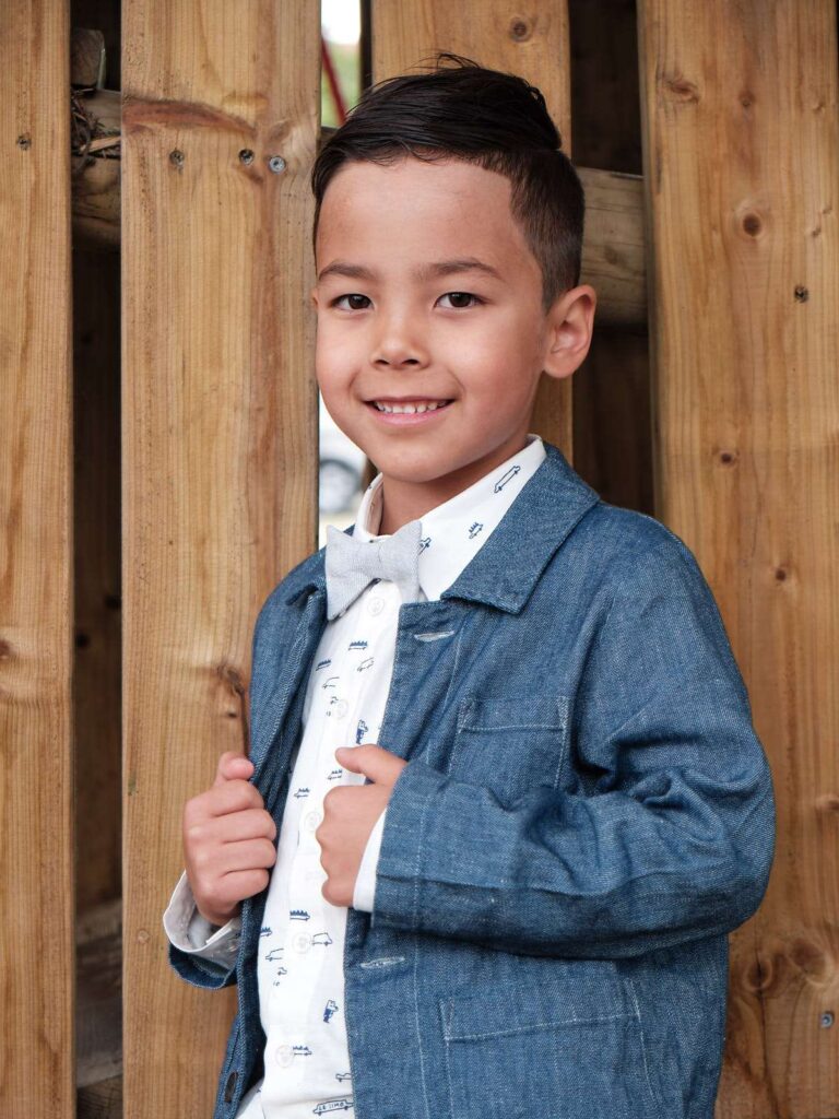Portait of boy posing for communion photos.