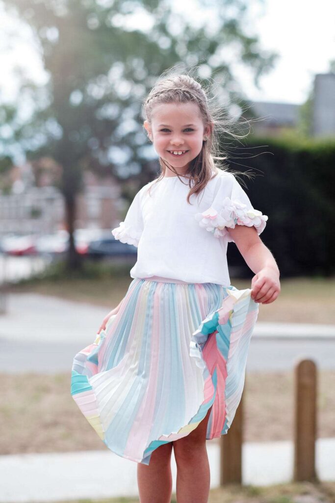 Portrait of smiling girl swinging her skirt