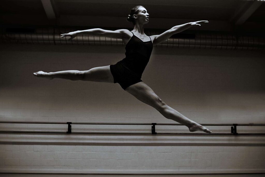 Girl jumping in dance pose.