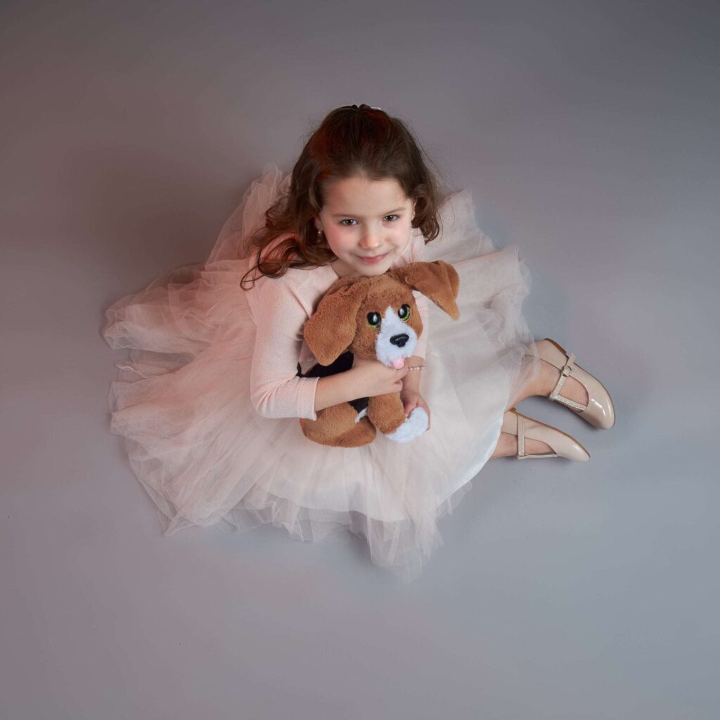 Girl posing with teddy.