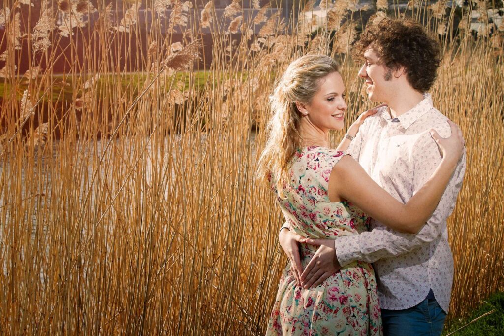 Photo of a couple posing outside in nature.